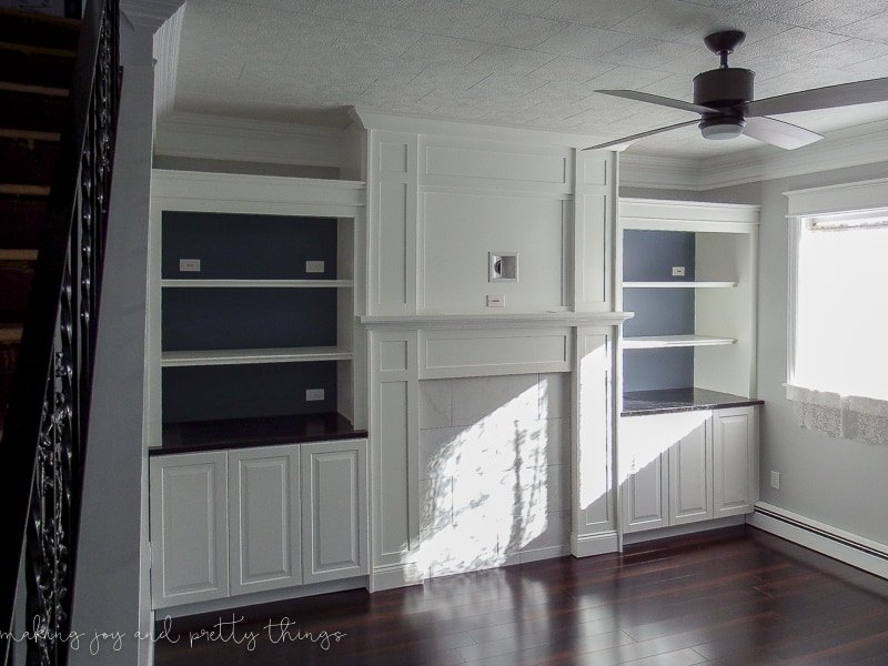 Use IKEA built ins around your fireplace to create shelving and much needed countertop space. These kitchen cabinets are an amazing storage option in your living room.