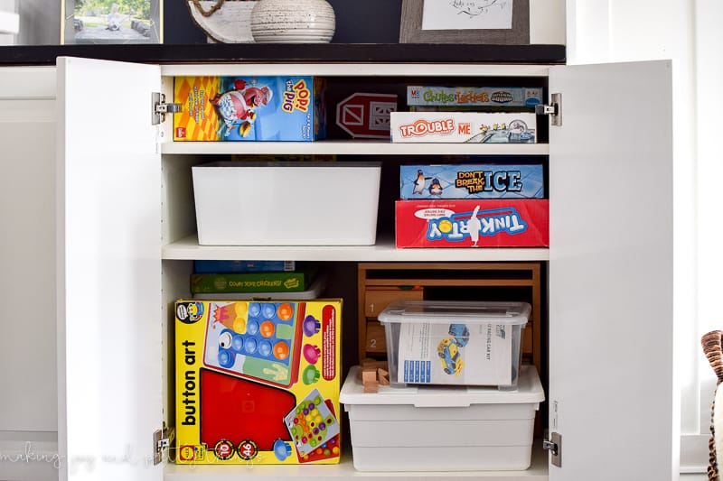 DIY IKEA built in cabinets easily store board games and other items around a living room. 