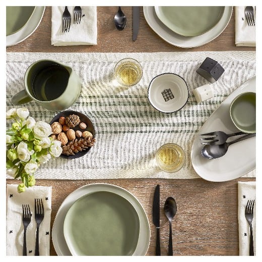 A photo of a green-themed dining table with utensils.