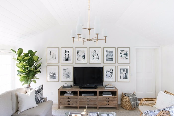 This living room photo display is a great gallery wall idea if you are looking for a tasteful way to hang photos to decorate the wall around your television.