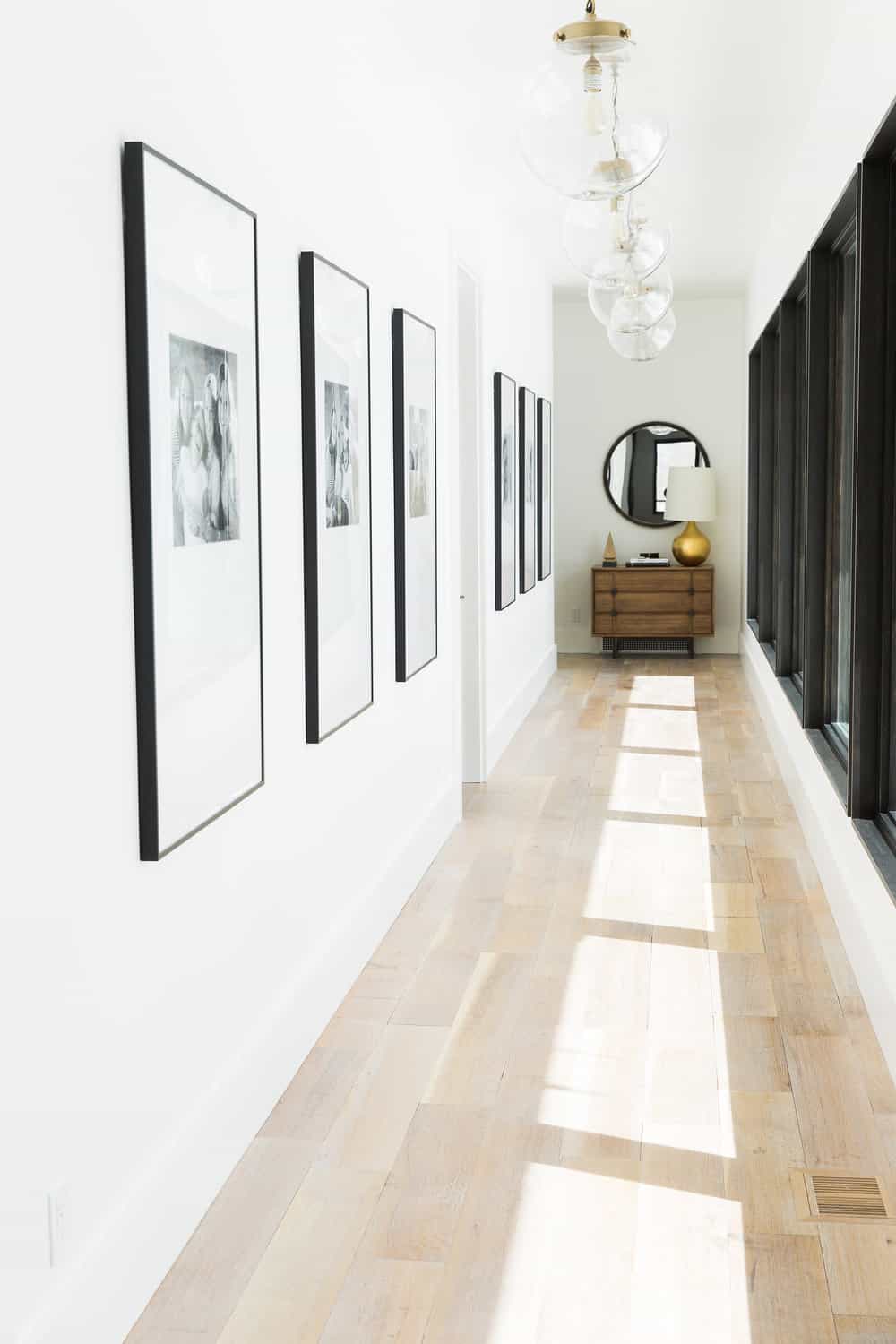 A hallway is a great place if you are wondering how to display family photos in a tasteful way in the parts of your house you walk through