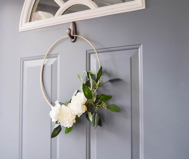 Winter wreath hung on the front door shows off some flair all winter long and really shines with floral and greenery accents