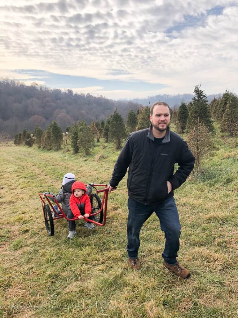 A family hiking around looking for that perfect Christmas Tree at Grupps Tree Farm