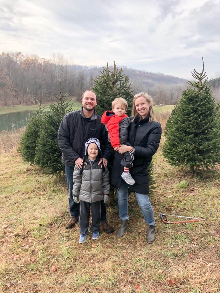 Picture of a family enjoying time at Grupps Tree farm picking out a Christmas tree together 