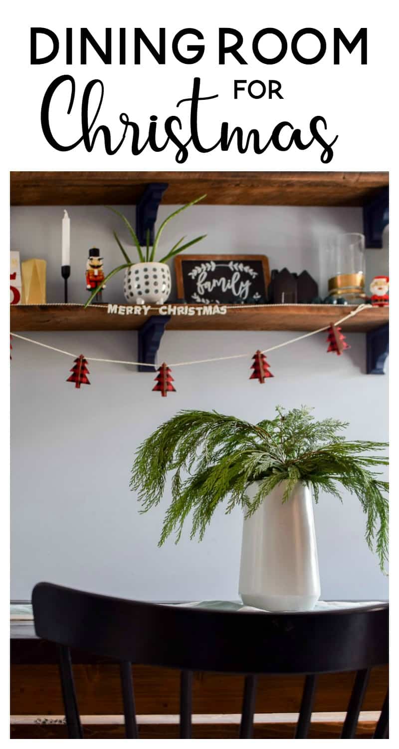 Beautifully decorated dining room for Christmas with minimalistic designs and fresh greenery for accents