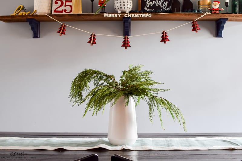 Close up of cedar trimmings used as a farmhouse style dining room Christmas decor item for a dining table