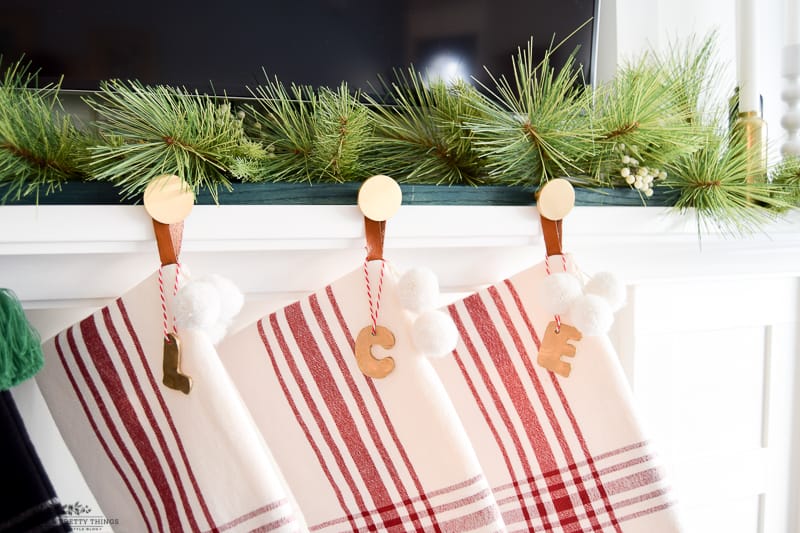 Small letter tags for stockings made from oven bake polymer clay attached to plaid modern stockings hanging on mantel