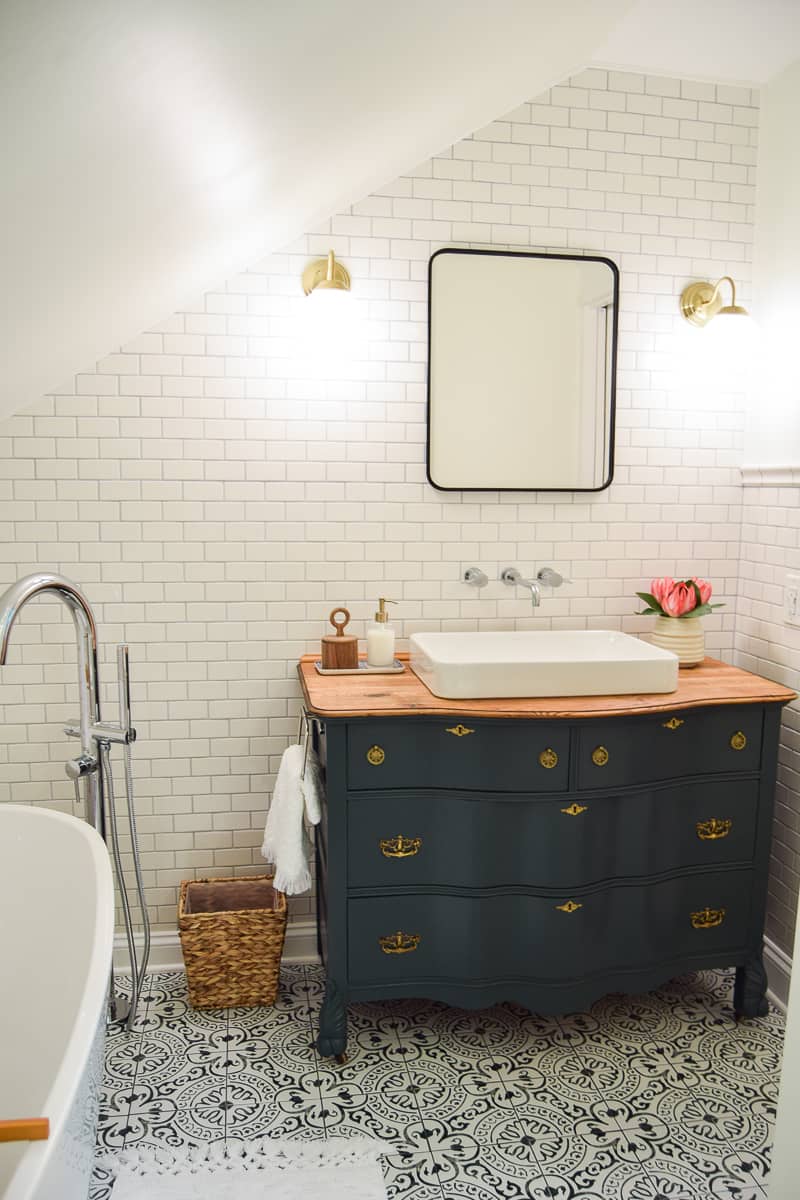A look at the floor tiles and vintage vanity in our modern vintage bathroom. These black and white times have a unique design that balances the simplicity in other design elements of our master bathroom.