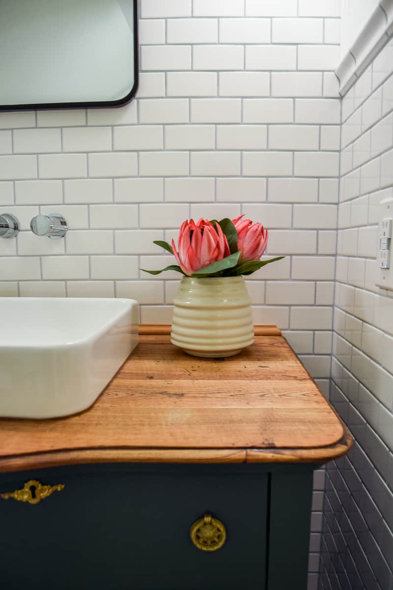 A love the natural wood grain that was revealed when we sanded down the top of this vanity! It goes perfectly with the white porcelain sink we installed.