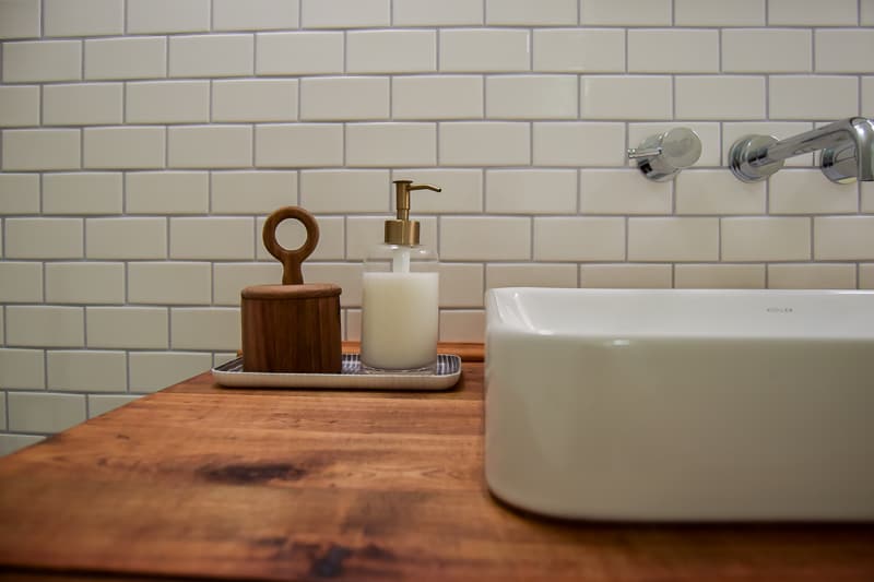 A closer look at some finer details of our modern vintage bathroom makeover - the soap dispenser tray next to the inlayed porcelain sink.