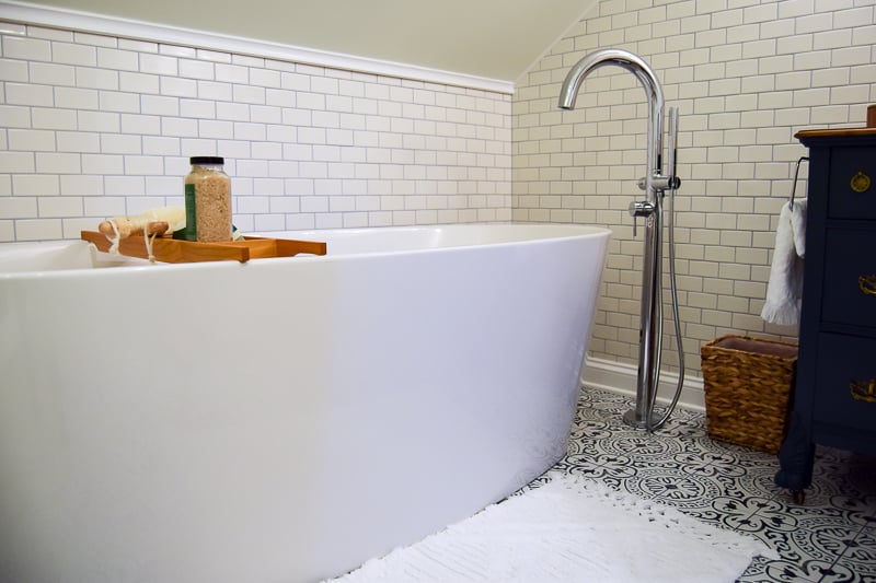 A complete look at the deep soaking tub and filler against the white subway tiled walls in our vintage modern bathroom makeover.