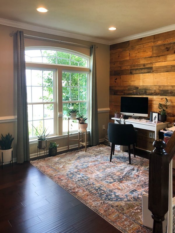 A nice office space built out with contractor grade finishes and a wood plank wall that hasn't been renovated with an office mood board