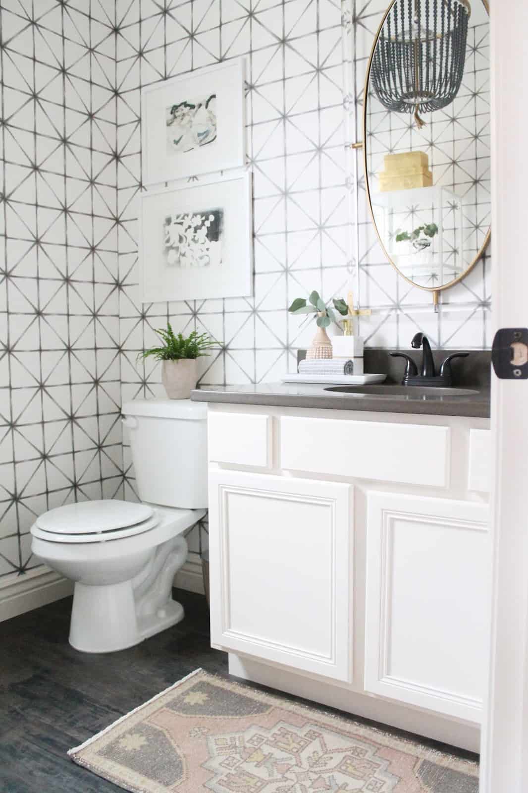 Modern bathroom design with black and white geometric wallpaper purchased from Wayfair installed on the walls 