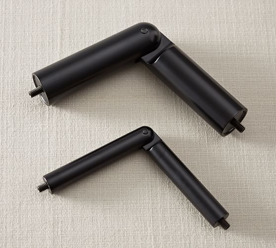 Black metal curtain rod connectors, one larger and one smaller, bent at a right angle.