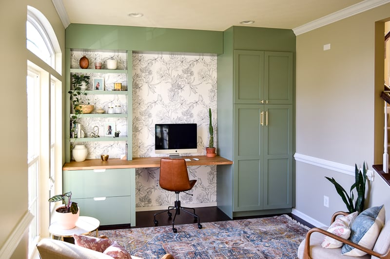 View of a living room being used as a modern office that is very trendy and pretty 