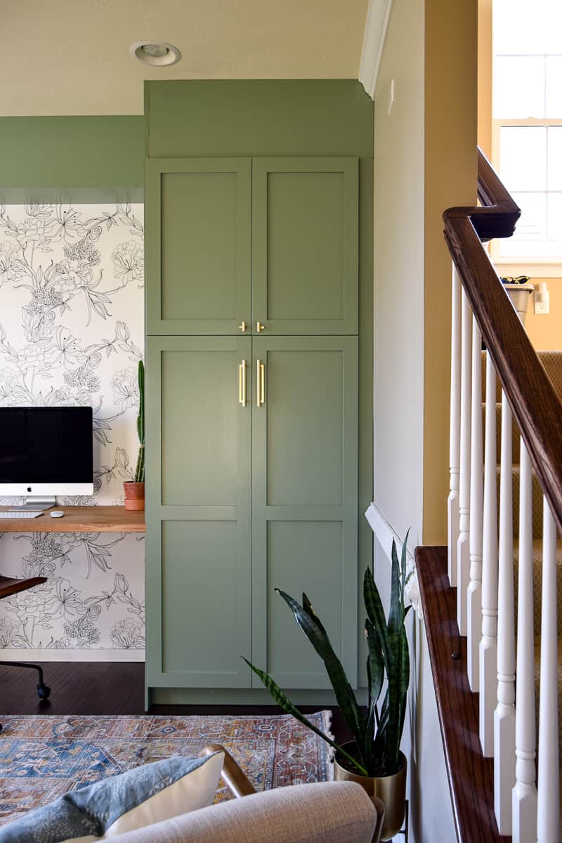 Using an IKEA pantry for every day items in a living room converted to modern office is a unique storage option