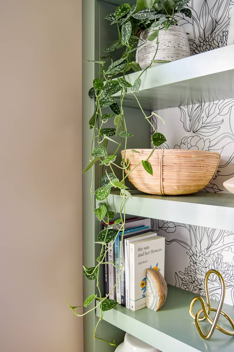 Ad a variety of colors to shelving to contrast a modern office in the living room