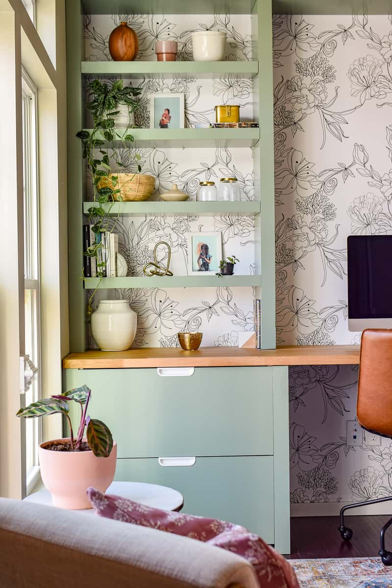 Tie in your floral wallpaper to your office using pots and plants on your shelves to create a seamless look