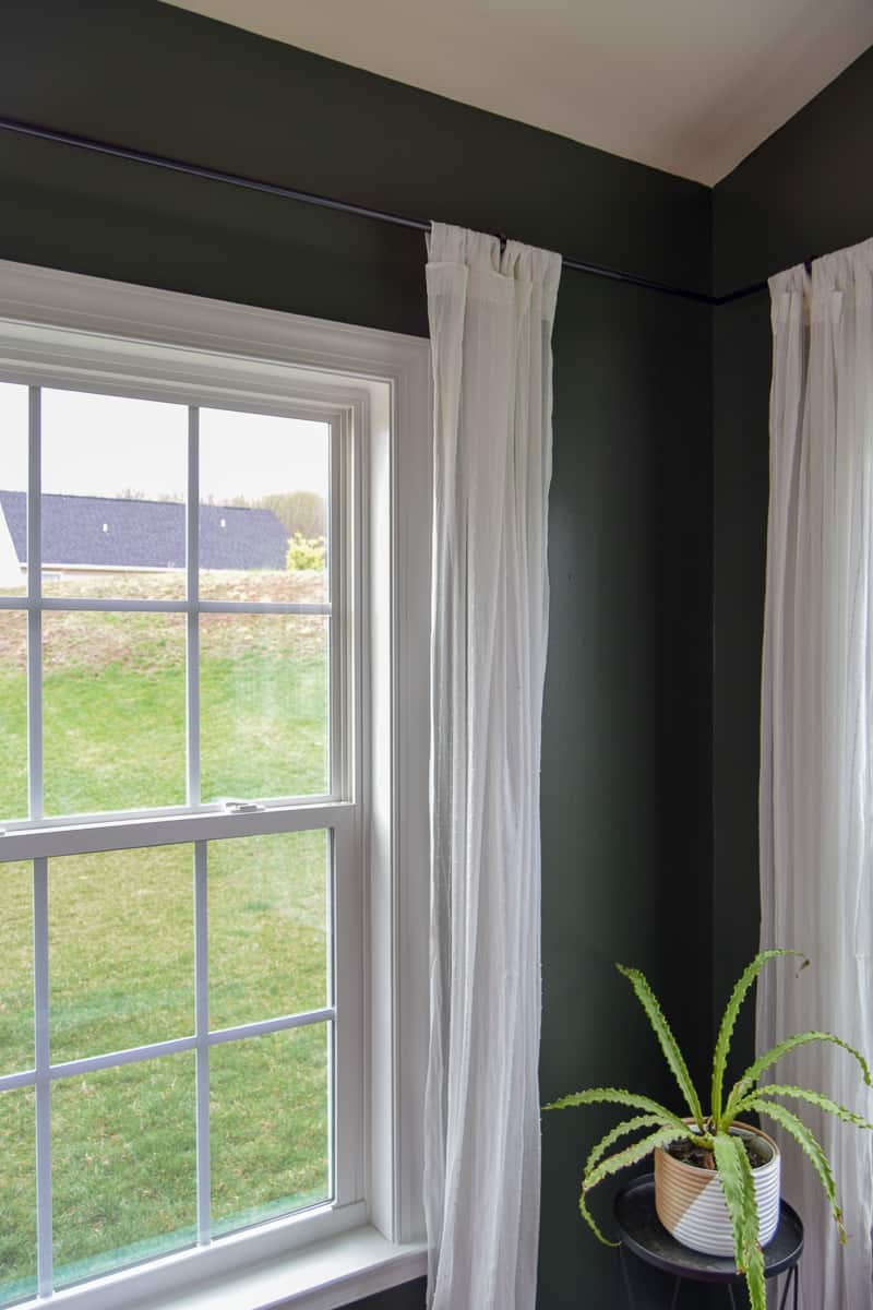 Showing off ikea curtains with a curtain rod and corner connecters to create a seamless look all around the room