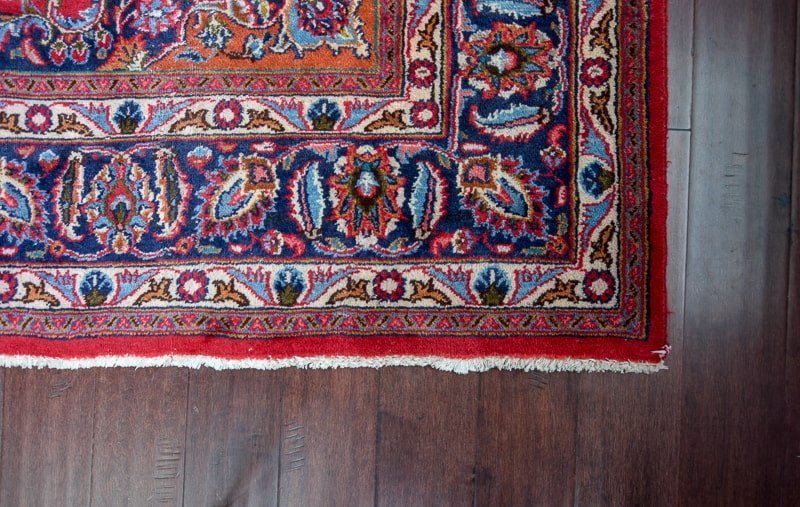 Using a rug over hardwood floors is a great way to preserve the floors and give some contrast to break up the floor