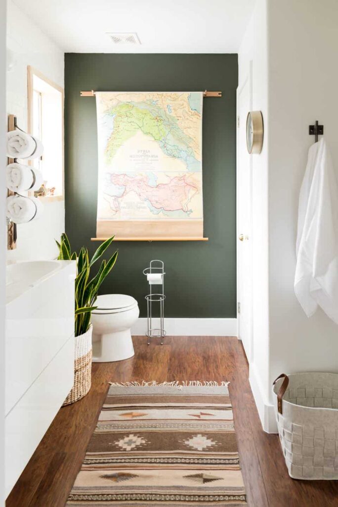 A bold painted wall is automatically a focal point in this modern bathroom from Vintage Revivals. I love the dark green paint color on the feature wall and how it contrasts with the other white walls. 
