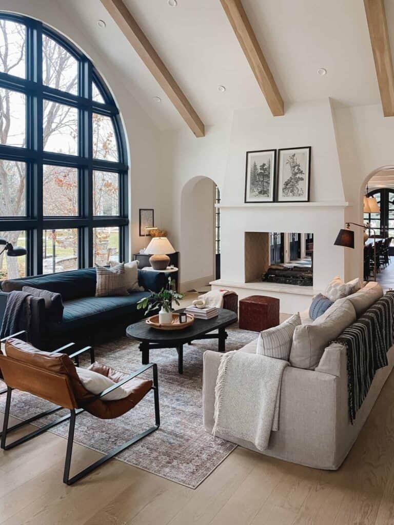 How gorgeous is this massive arched window in the living room by Chris Loves Julia?
