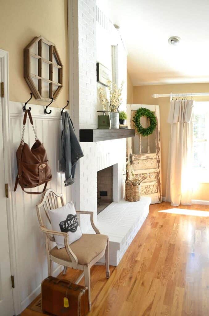 This fireplace was redone using paint over brick to make it stand out in this living room while flowing with the trim