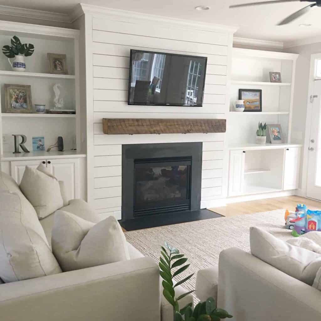 Shiplap is a great idea to cover up an old brick fireplace that really pops with a oversized rough sawn mantle