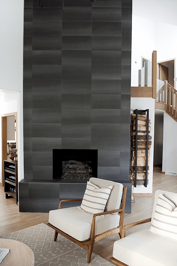 Redoing a hearth with black floor to ceiling tile really gives a sleek and simple look to any living room