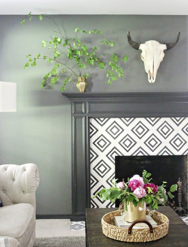 Stencils are a great way to paint on a design on an existing fireplace that provides a much needed update
