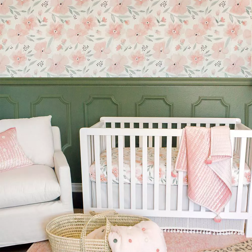 I love this green painted wall paneling on the bottom part of the wall with pink flower wallpaper design on the top part. Perfect for a baby girl's nursery and it comes with matching bedding. 