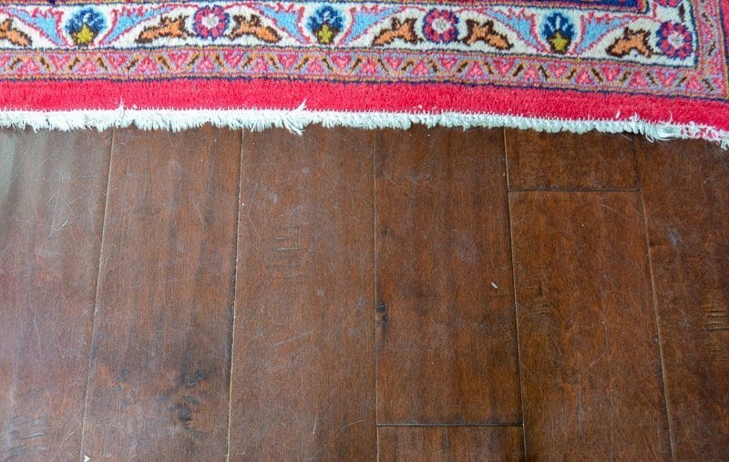 Close up before picture of dirty hardwood floors before deep cleaning them 