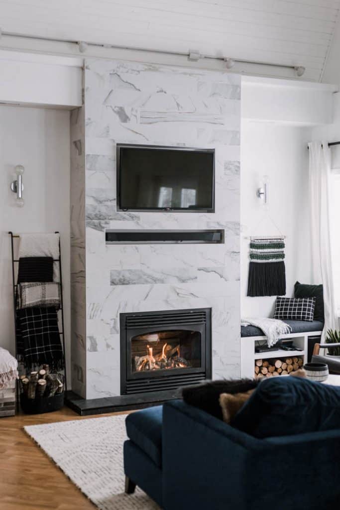Floor to ceiling fireplace update really makes it pop with a recessed mantle and beautiful stone tones