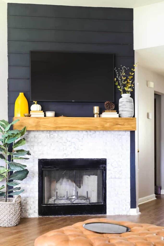 You can modernize a brick fireplace using shiplap in combination with a tile update to really make it eye catching