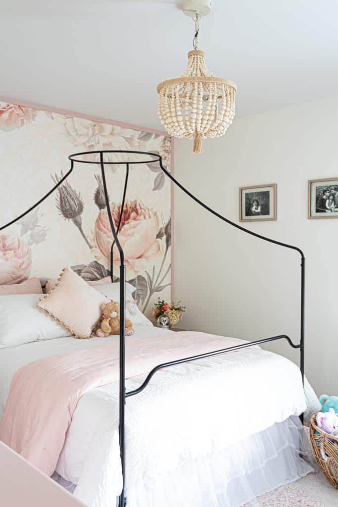I love this gorgeous and girl bedroom with large patterned floral wallpaper accent wall with rosebuds 