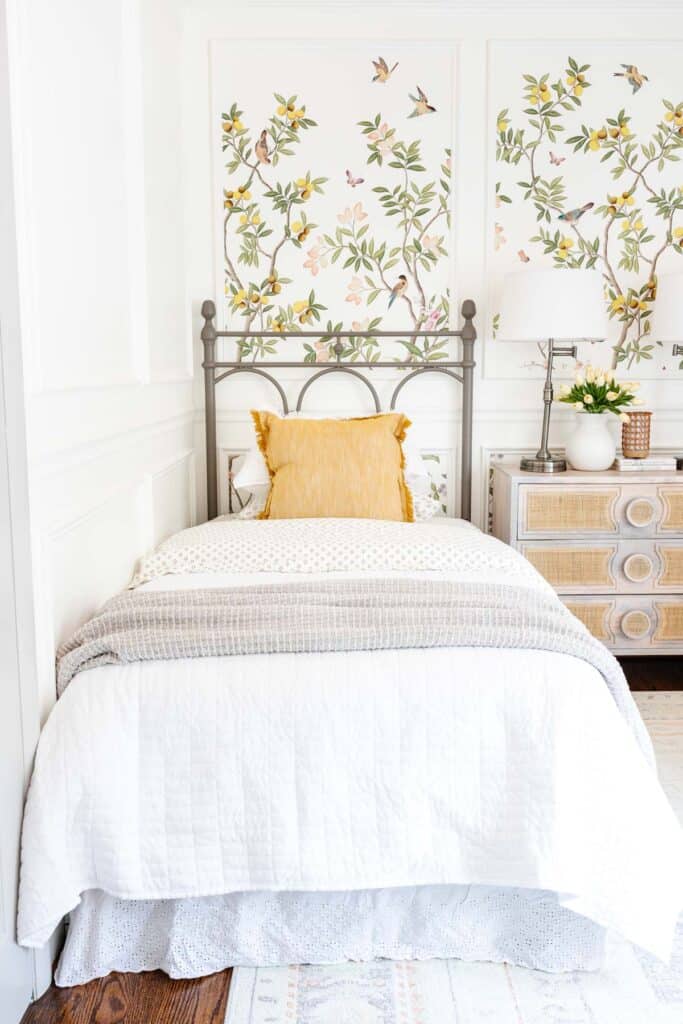 There are several different ways you can install wallpaper or wall murals in a nursery or little girl's bedroom. I love this method of putting the floral wall mural inside picture frame molding on the wall.