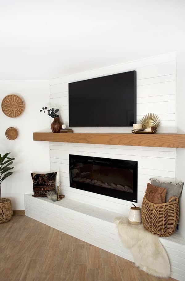 How to use shiplap and a mantle to create multiple spaces above a brick fireplace.