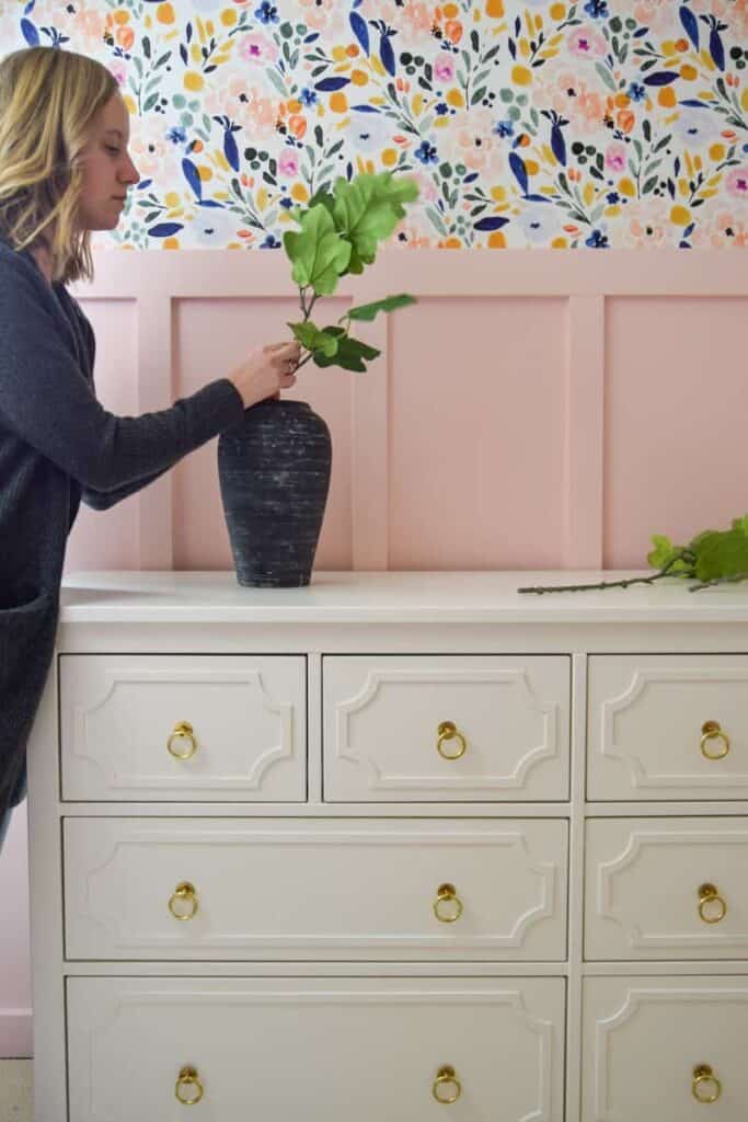 I used this DIY aged black pottery as a faux greenery vase in my daughter's room. It sits on the dresser, a stark contrast to the pink shiplap wall behind it.