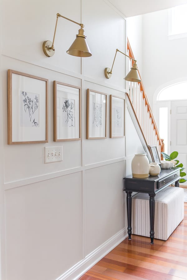 The entryway boasts a fresh coat of Dover White paint color, welcoming guests with its timeless charm.