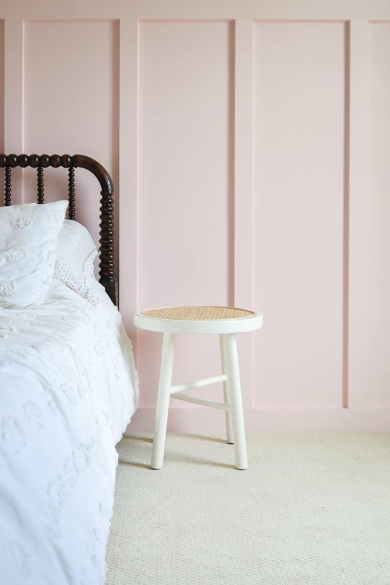 Looking for DIY nightstand ideas? I tried my hand at DIY cane projects with a DIY cane nightstand for Evie’s toddler girl room! I used a stool from Target, some spray paint, and cane to make a DIY nightstand. It’s the perfect addition to a little girl’s room if you’re looking for girl room ideas. The DIY cane nightstand was an easy DIY that adds tons of style and function to her girly room. #cane #canefurniture #diyprojects #diycanenightstand