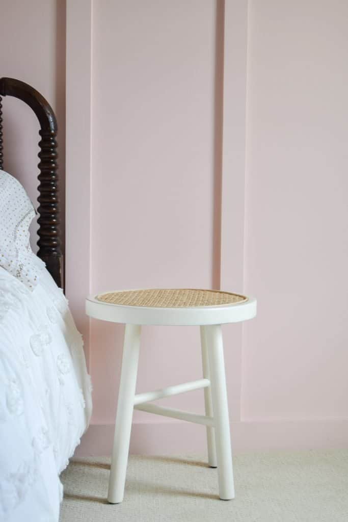 Looking for DIY nightstand ideas? I tried my hand at DIY cane projects with a DIY cane nightstand for Evie’s toddler girl room! I used a stool from Target, some spray paint, and cane to make a DIY nightstand. It’s the perfect addition to a little girl’s room if you’re looking for girl room ideas. The DIY cane nightstand was an easy DIY that adds tons of style and function to her girly room. #cane #canefurniture #diyprojects #diycanenightstand