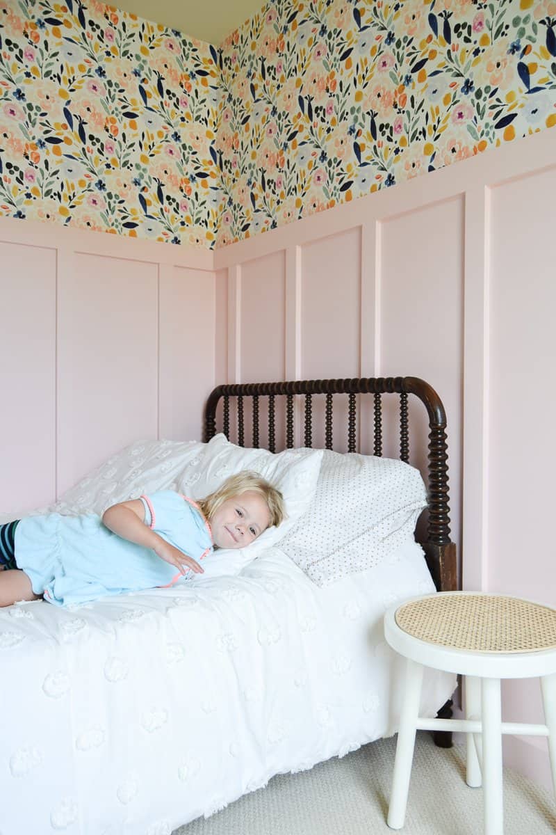 Looking for DIY nightstand ideas? I tried my hand at DIY cane projects with a DIY cane nightstand for Evie’s toddler girl room! I used a stool from Target, some spray paint, and cane to make a DIY nightstand. It’s the perfect addition to a little girl’s room if you’re looking for girl room ideas. The DIY cane nightstand was an easy DIY that adds tons of style and function to her girly room. #cane #canefurniture #diyprojects #diycanenightstand