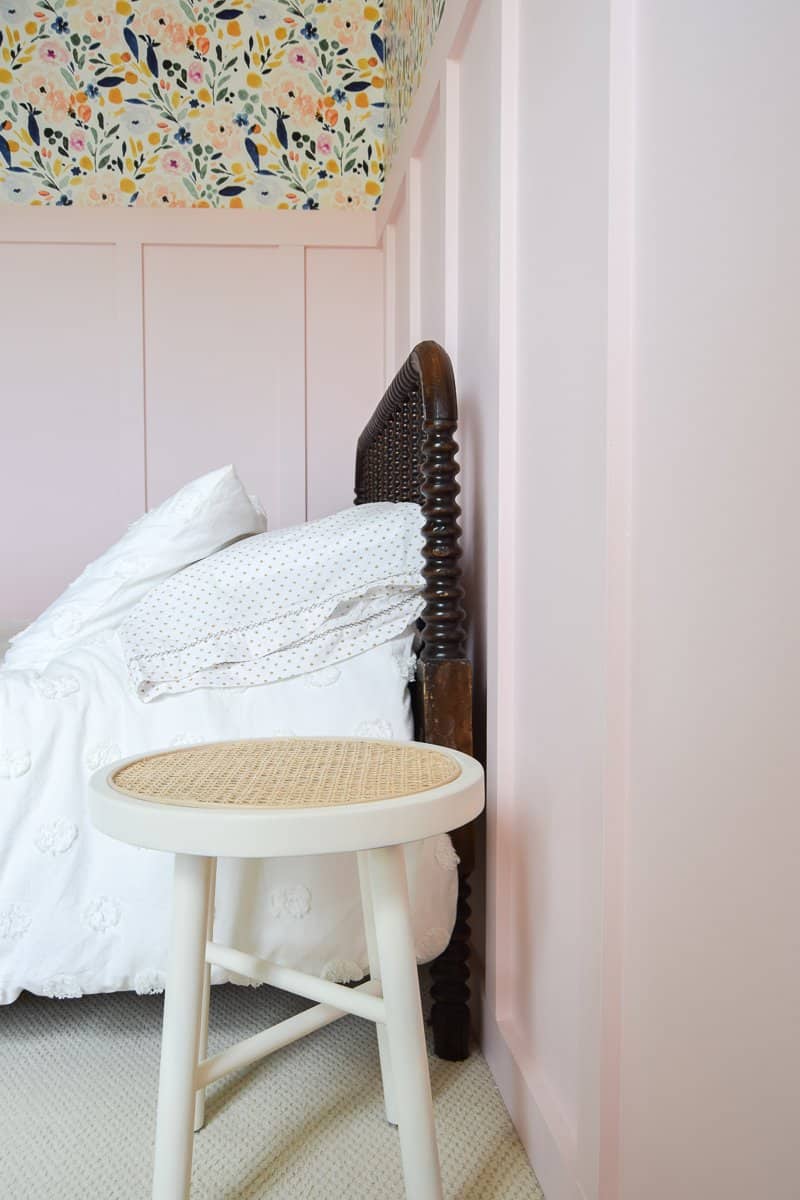 Looking for DIY nightstand ideas? I tried my hand at DIY cane projects with a DIY cane nightstand for Evie’s toddler girl room! I used a stool from Target, some spray paint, and cane to make a DIY nightstand. It’s the perfect addition to a little girl’s room if you’re looking for girl room ideas. The DIY cane nightstand was an easy DIY that adds tons of style and function to her girly room. #cane #canefurniture #diyprojects #diycanenightstand
