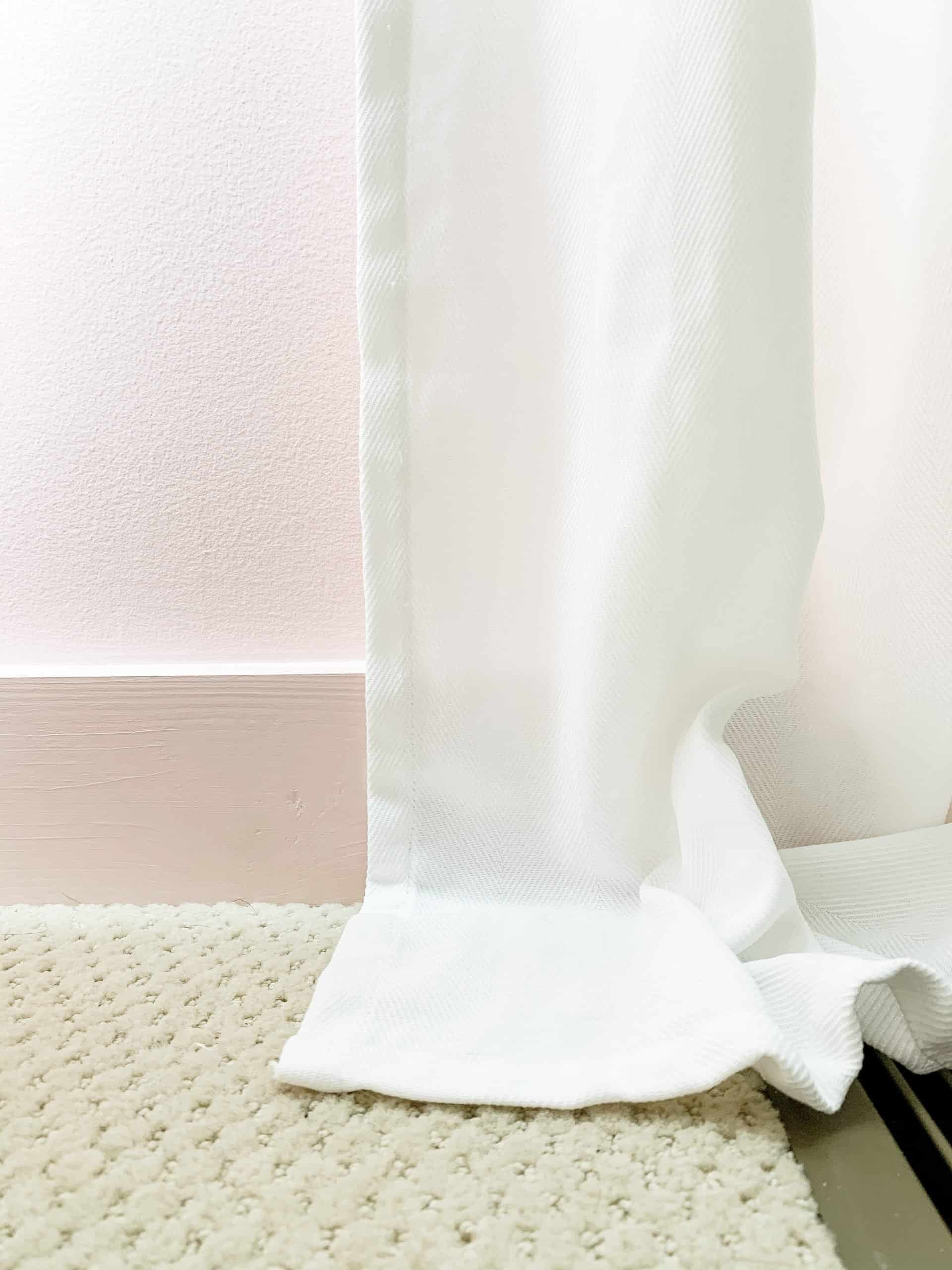 Today I’m sharing how to hem curtains without sewing. Curtains should just barely touch the floor or hover just slightly over the floor. In order to hem curtains, you normally have to hem curtains with a sewing machine. Since I don’t know how to sew, I’m going to show you how to hem curtains with hem tape and an iron. Let’s hem curtains the easy way with a no sew method. All you need for no sew curtains is hem tape and an iron. For this project I used fusing web! #curtains #howtohemcurtains #hemcurtains #nosewcurtains