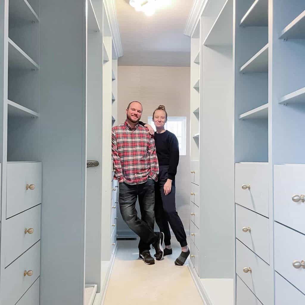 A photo of a man and woman with their closet cabinet.