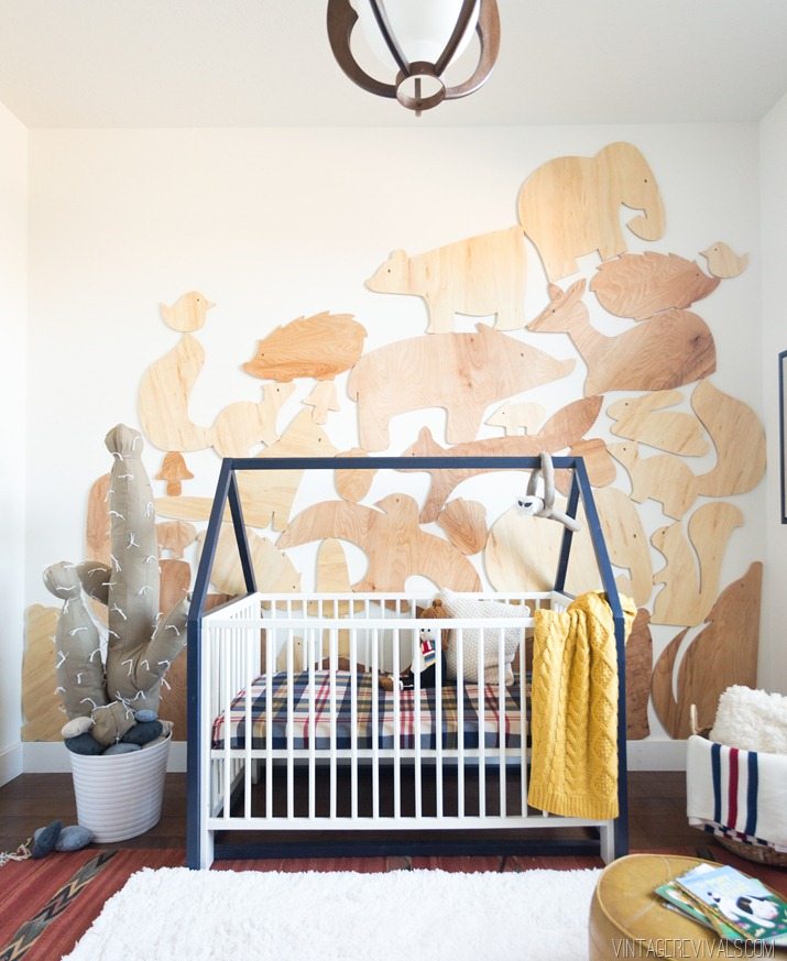 Boys nursery with wood accent wall with cut out animal shapes