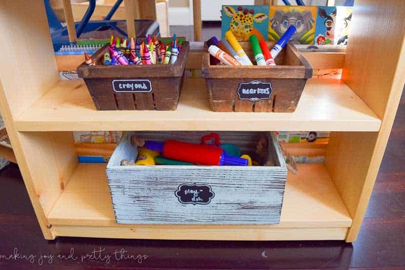 Organize everything in a kid's room in baskets, like this shelving unit with baskets for crayons, markers and play-doh toys