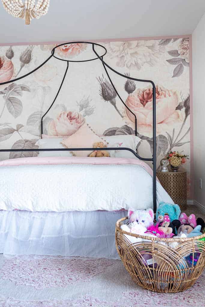 I love the basket with stuffed animals stored at the foot of the bed in this little girl's room.
