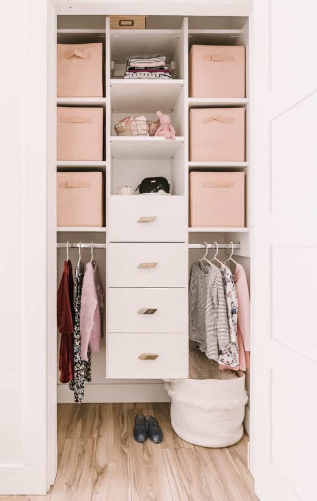 I love this kid's closet area with hanging rods below that little kids can reach and shelves with baskets on the top 