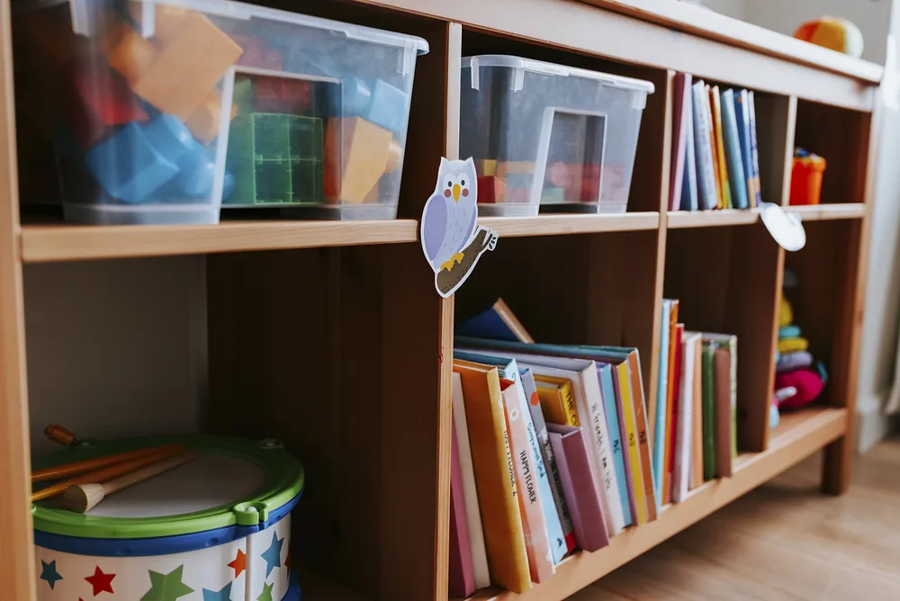 Low wooden shelves, like this, are great for kid's room organization. Use the shelves for clear storage bins, books and other toys. 